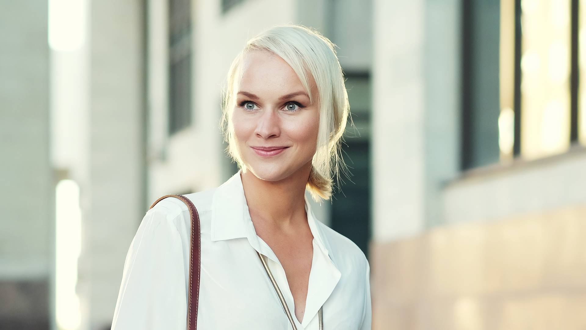 young blond woman walking on the street